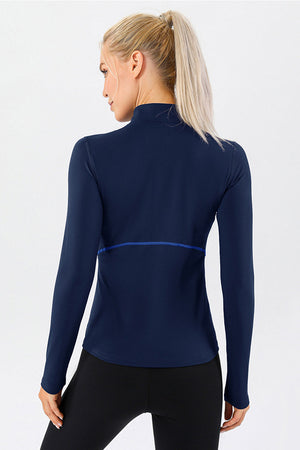 Dark blue athleisure zip-neck top with contrast seam detail and long sleeves.
