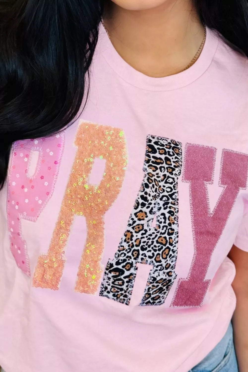 Pink cotton t-shirt with sequin and leopard print PRAY graphic patch detail.