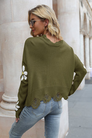 Olive brown acrylic sweater with distressed edges and daisy appliqués on sleeves.