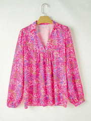 Hot pink graphic mesh sleeve blouse with V-neck and gathered waist.