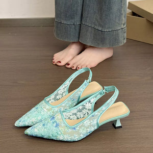 Elegant lace slingback kitten heels in mint green with floral pattern and adjustable ankle strap.