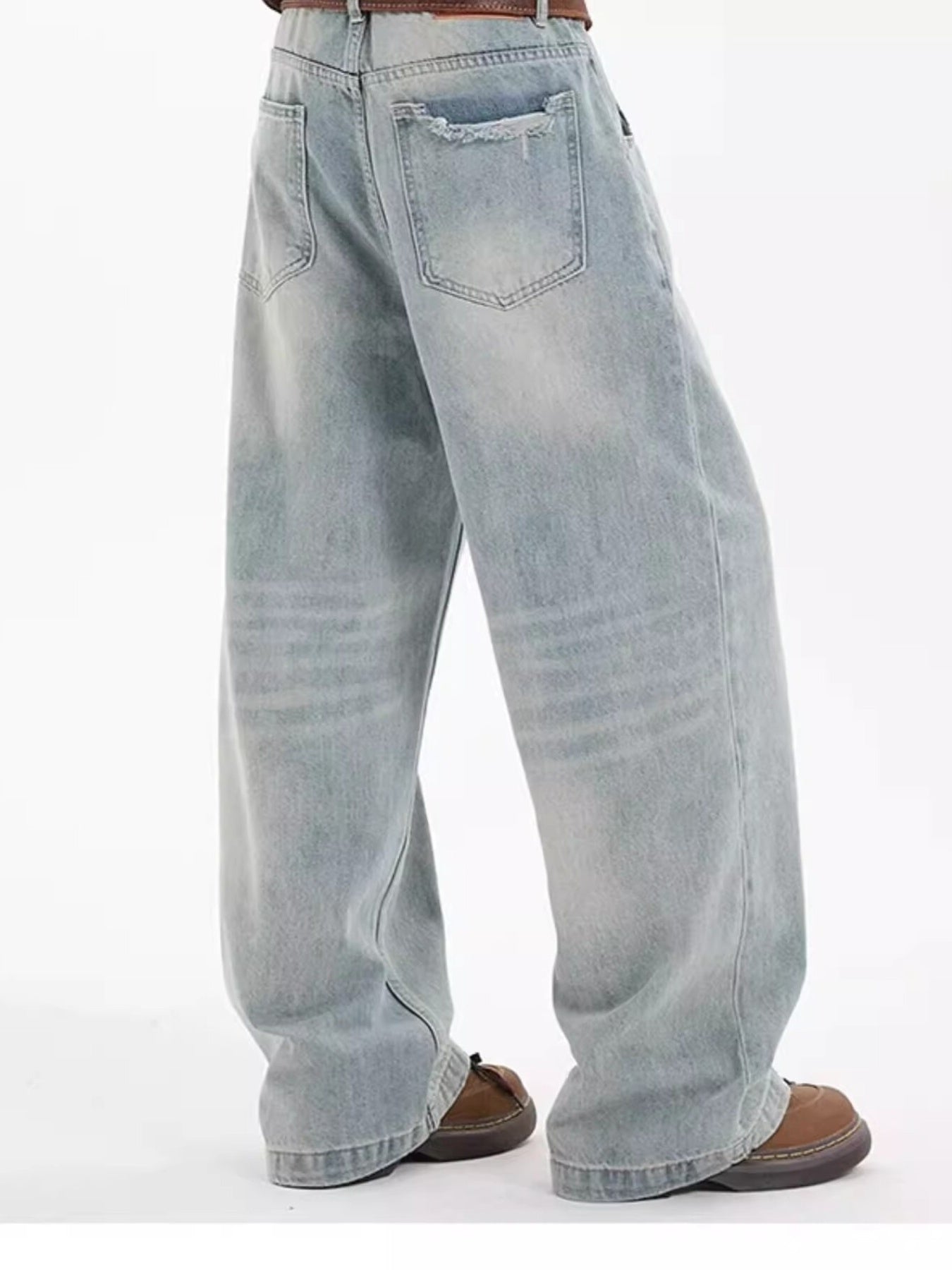 Washed blue cotton wide-leg jeans with distressed back pocket detail.
