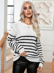 White cable-knit sweater with black stripes and shoulder buttons