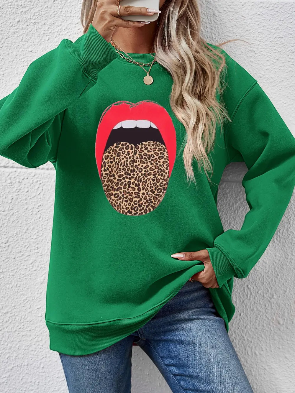 Green sweatshirt with red lips and leopard tongue graphic.