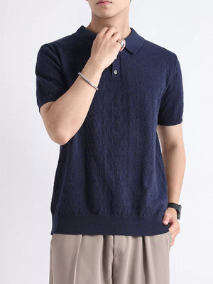 Navy short-sleeve knit polo shirt with button detail and classic collar.