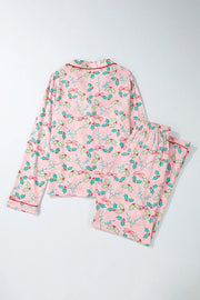 Blush pink pajama set with holly and bow print, long sleeves, and piped collar.