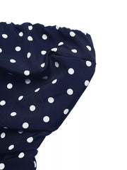 Navy polka dot A-line maxi dress detail showing fabric texture and pattern.