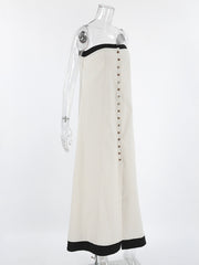Beige cotton blend tube maxi dress with button front and black trim detail.
