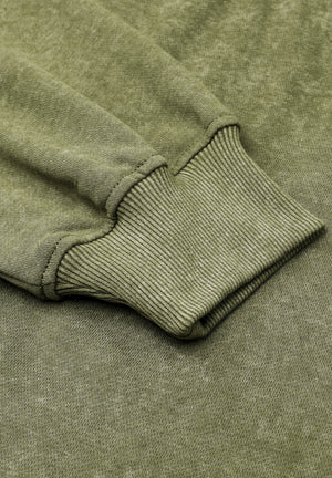 Moss acid wash sweatshirt sleeve detail with ribbed cuff and textured fabric.