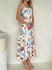 Midi dress with seashell print, scalloped trim, spaghetti straps, and tie back.