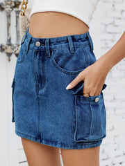 Medium wash denim cargo mini skirt with button flap pockets.