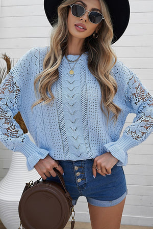 Light blue openwork knit sweater with lace sleeves and ruffled cuffs.