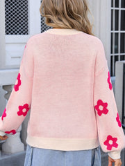 Pink knit sweater with allover hot pink floral print and cream trim.