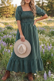 Plaid maxi dress with smocked bodice, square neck, puff sleeves, and ruffled hem.