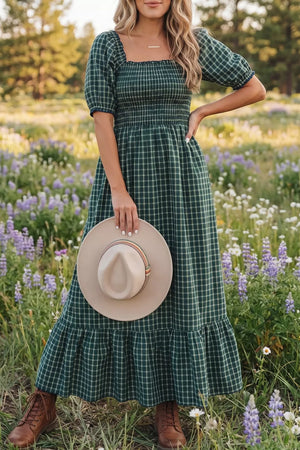 Plaid maxi dress with smocked bodice, square neck, puff sleeves, and ruffled hem.