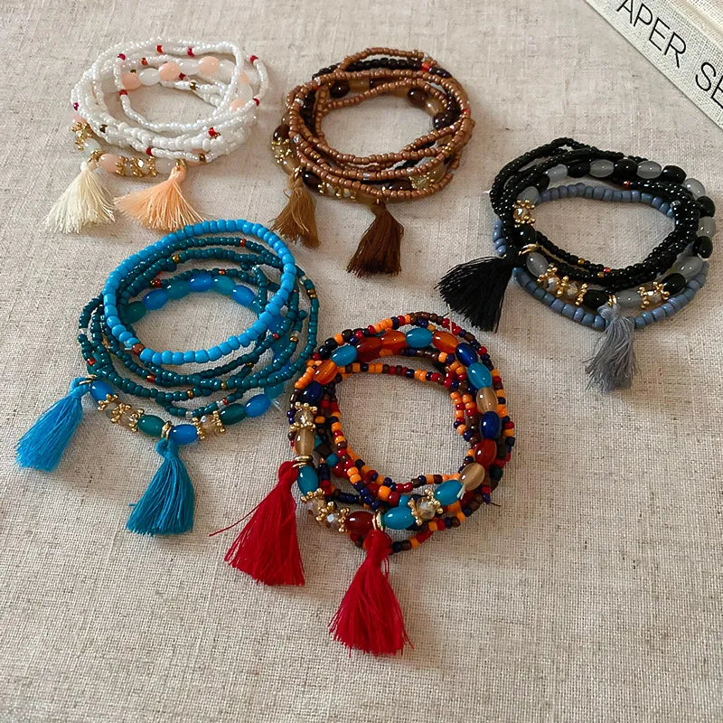 Beaded tassel stacked bracelet sets in white, coffee brown, royal blue, black, and multi-color.