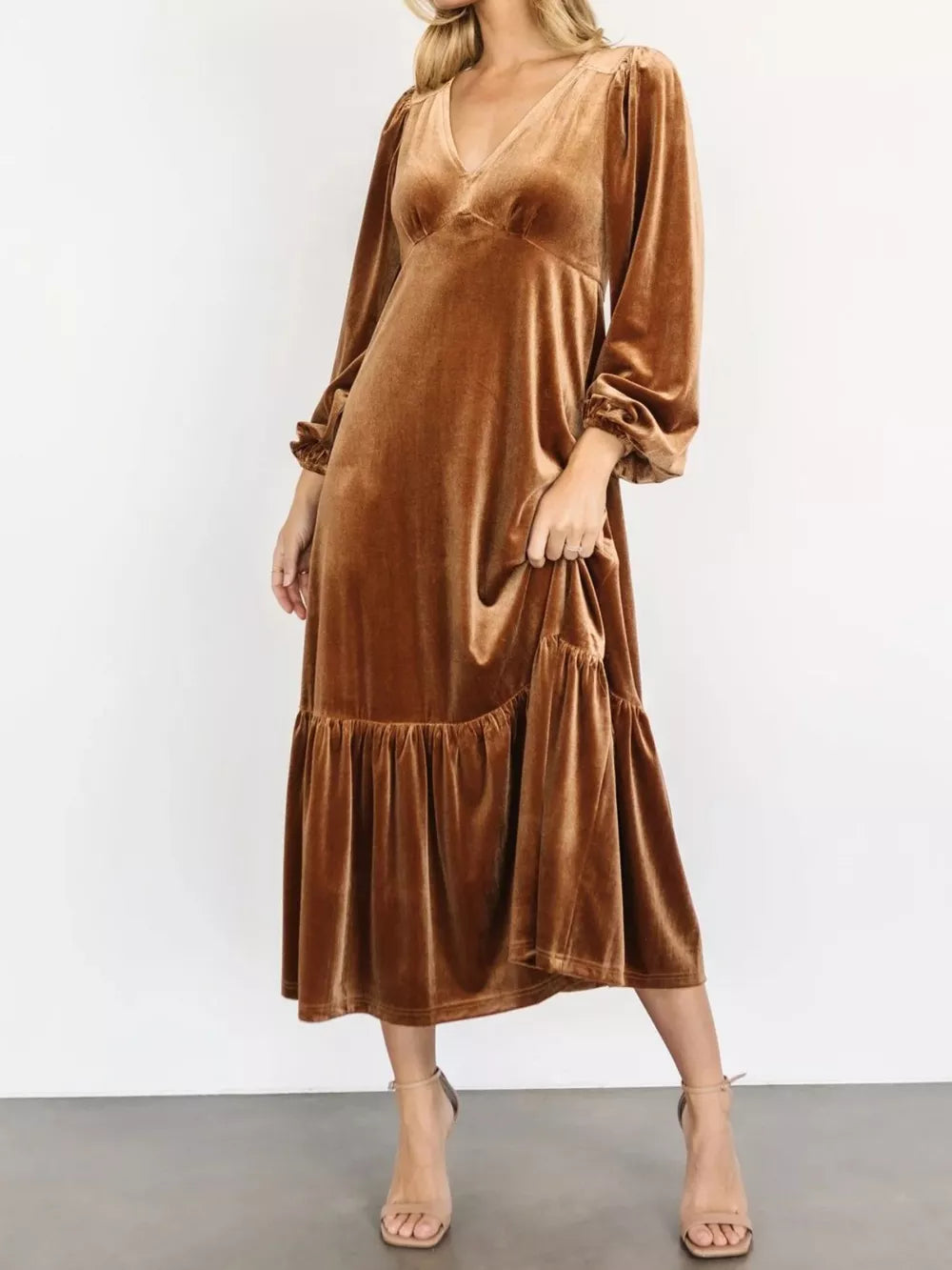 Gold velvet midi dress with tiered skirt and long puff sleeves.