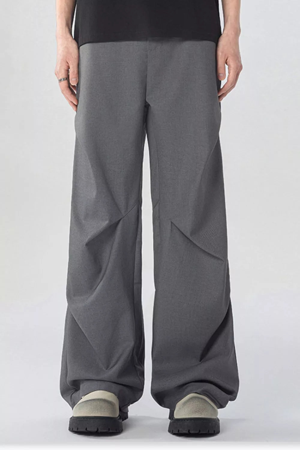 Men's gray wide-leg sweatpants with pockets and a relaxed fit.