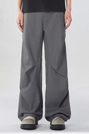 Men's gray wide-leg sweatpants with pockets and a relaxed fit.