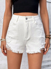 White denim shorts with distressed details and frayed hem