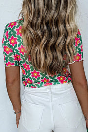Floral tee with scallop trim and short sleeves, styled with white jeans.