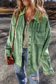 Green corduroy overshirt with button cuffs and chest pockets, worn open over a henley.
