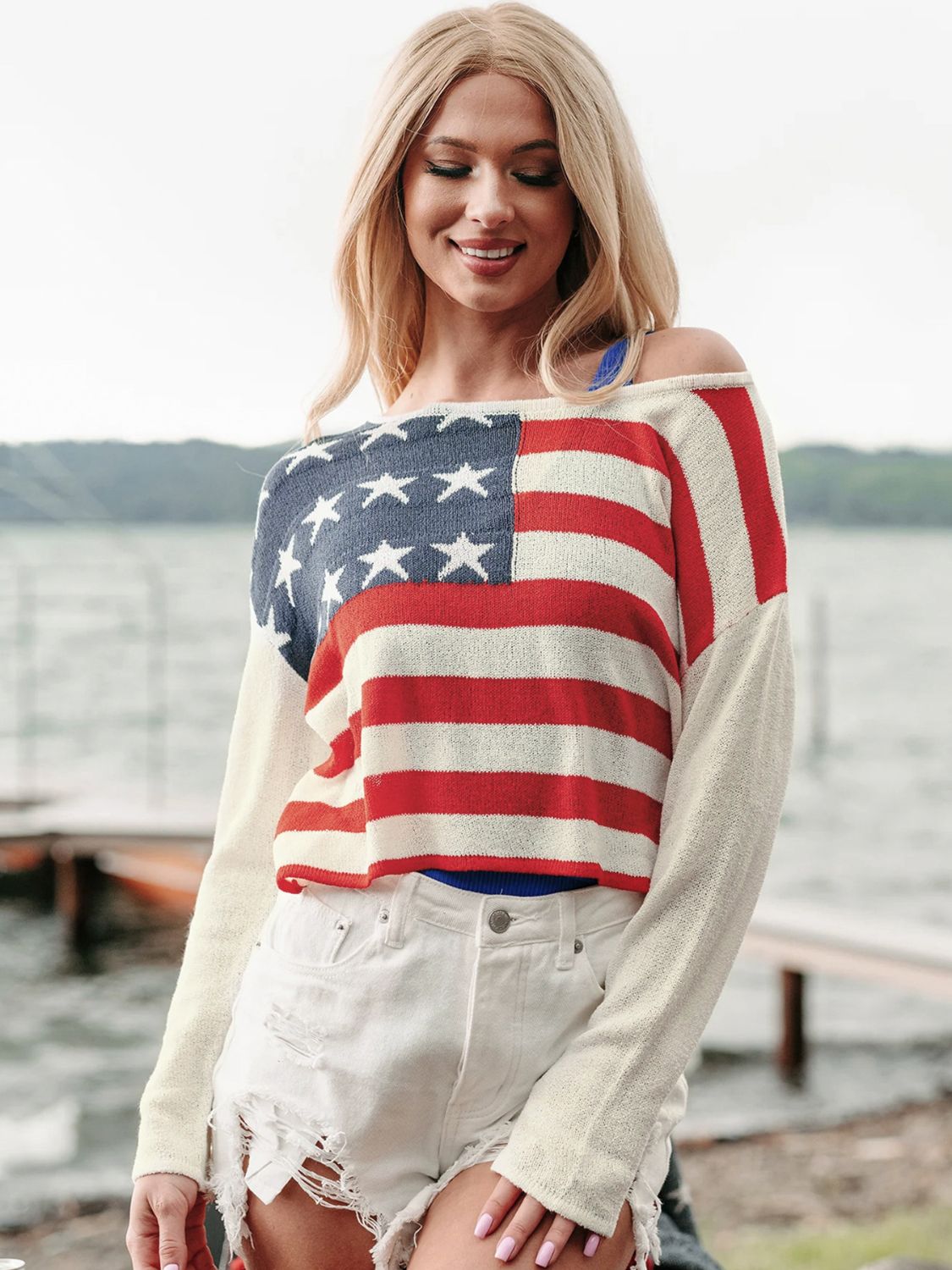 American flag off-shoulder knit sweater in ivory with red stripes and blue star detail.