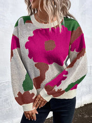 Abstract floral knit sweater with round neck in pink, green, brown, and cream.