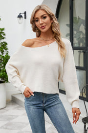 Off-shoulder ribbed knit sweater in white with balloon sleeves and a boat neckline.