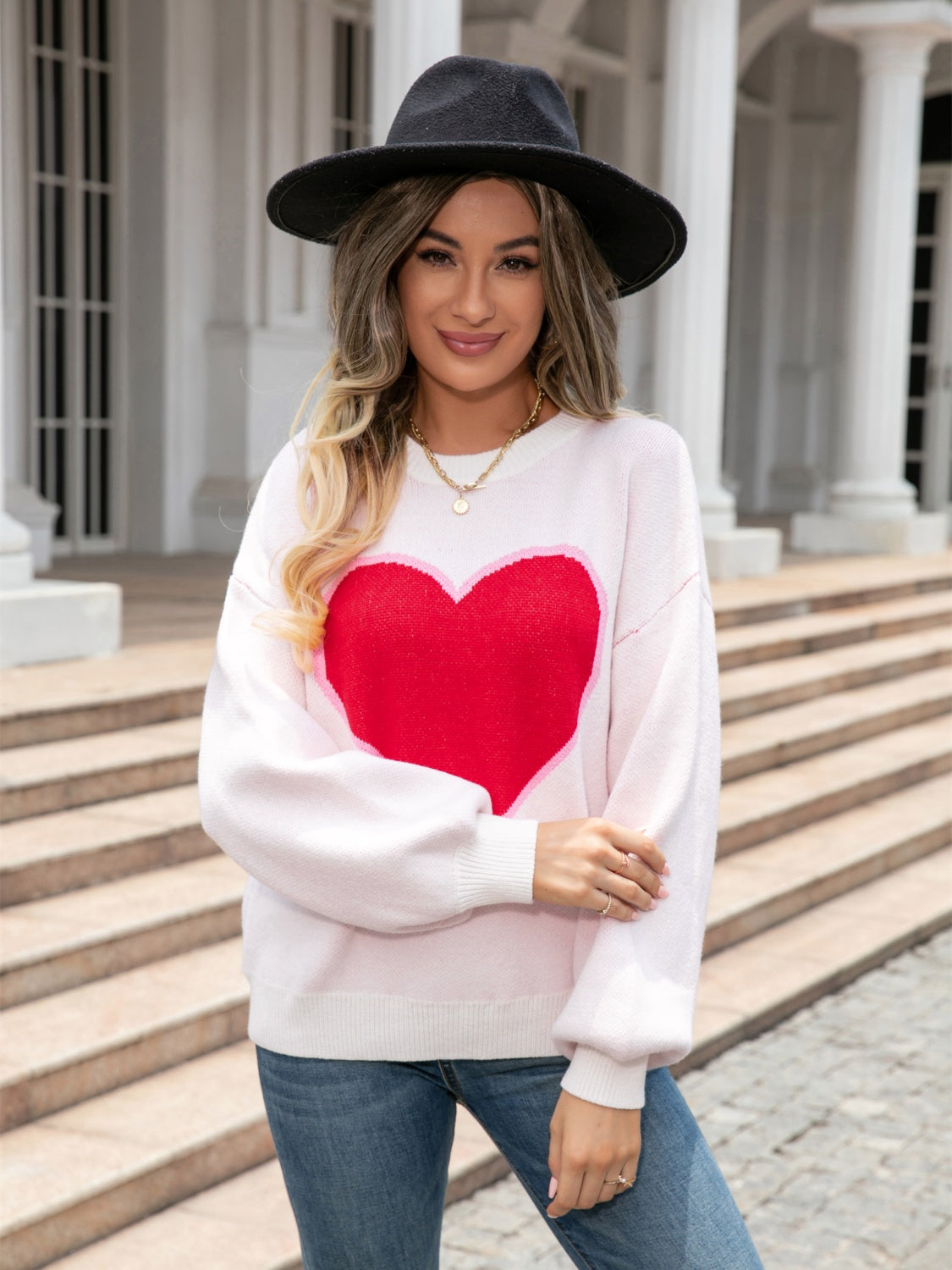 Pink acrylic sweater with large red heart motif and balloon sleeves.