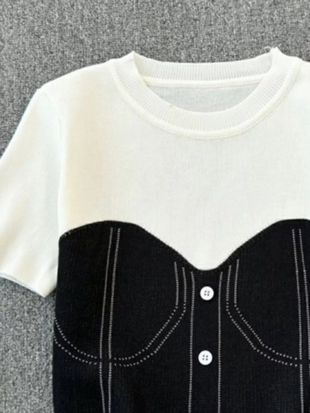 Color block knit t-shirt in white with black bustier detail and ribbed neckline.