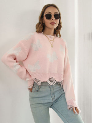 Blush pink cropped knit sweater with distressed butterfly print and frayed hem.