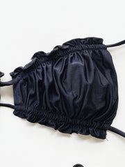 Black ruffle tie bikini top with ruched detail and tie straps.