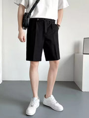 Men's black belted chino shorts with pleats and a relaxed fit.
