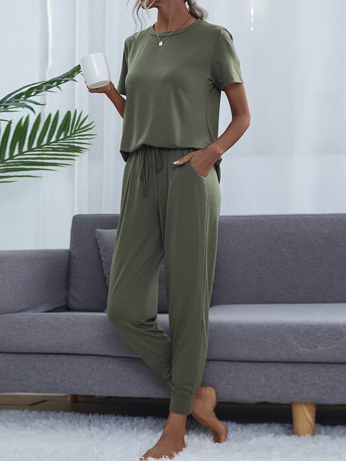 Moss green relaxed-fit tee and jogger set with drawstring waist and pockets.