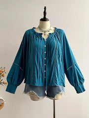 Teal ruffled lantern sleeve blouse with button-down front and crochet details.