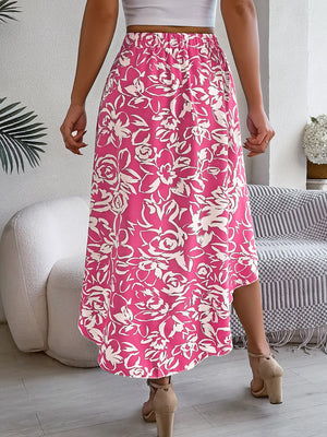 Fuchsia pink midi skirt with asymmetric hem and white floral print.