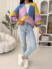 Pastel color block cardigan with balloon sleeves and open front, styled with jeans.