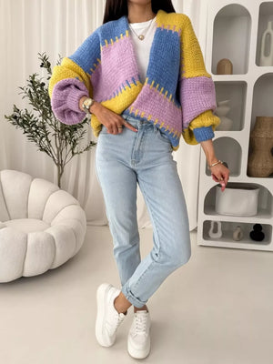 Pastel color block cardigan with balloon sleeves and open front, styled with jeans.