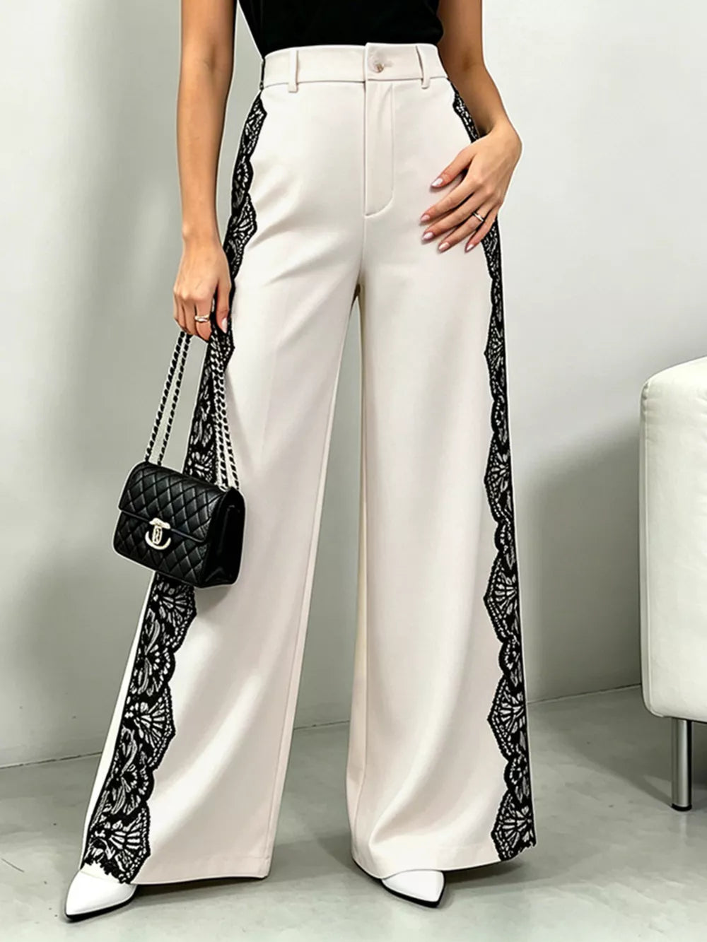 Lace-embellished high-waisted wide-leg maternity pants in cream with black lace side detail.