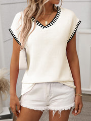 Cream knit v-neck sweater top with black contrast trim on neckline and sleeves