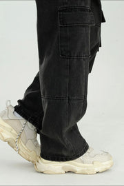 Black washed denim utility cargo pants with large side pockets.
