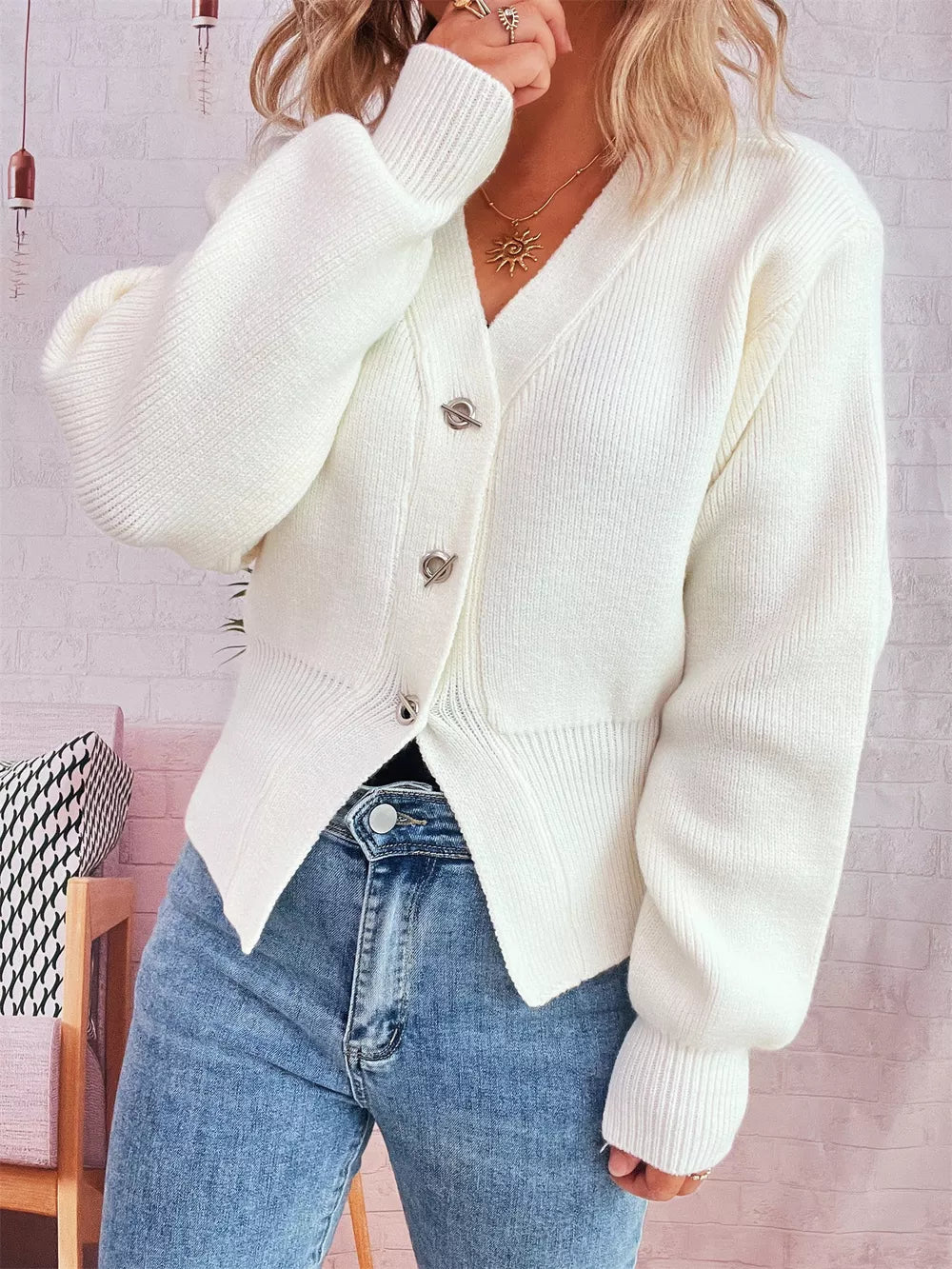 White ribbed V-neck button-through cardigan with silver buttons and balloon sleeves.