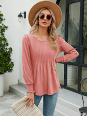 Pleated bodice gathered sleeve top in Burnt Coral with round neckline and smocked cuffs.
