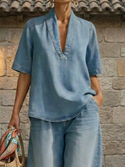 Blue cotton V-neck top with short sleeves and wide-leg pants, cuffed ankles, curved hem.