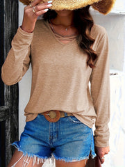 Tan long sleeve tee with crisscross neckline detail.