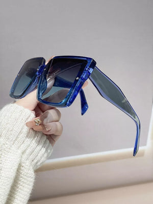 Oversized square gradient sunglasses in blue with thick acetate frames.
