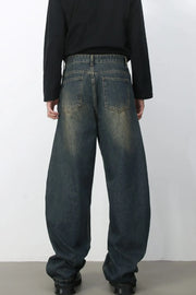 Faded baggy denim jeans in a dark blue wash with a relaxed fit.