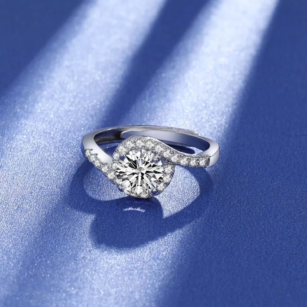 Dazzling Moissanite Halo Ring in silver with a swirling band of small stones.