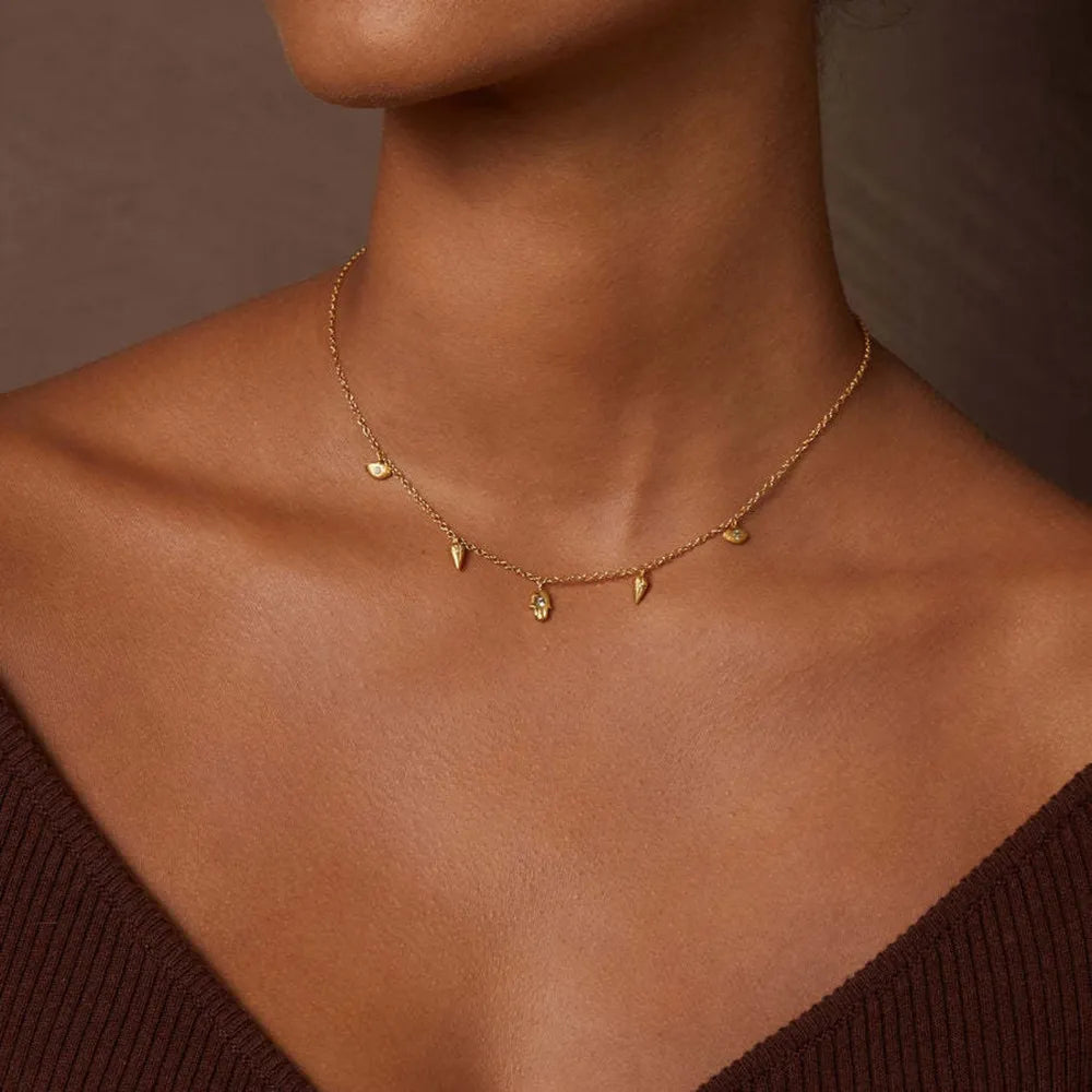 Gold layered necklace with spike and eye charms, 18K gold-plated brass.